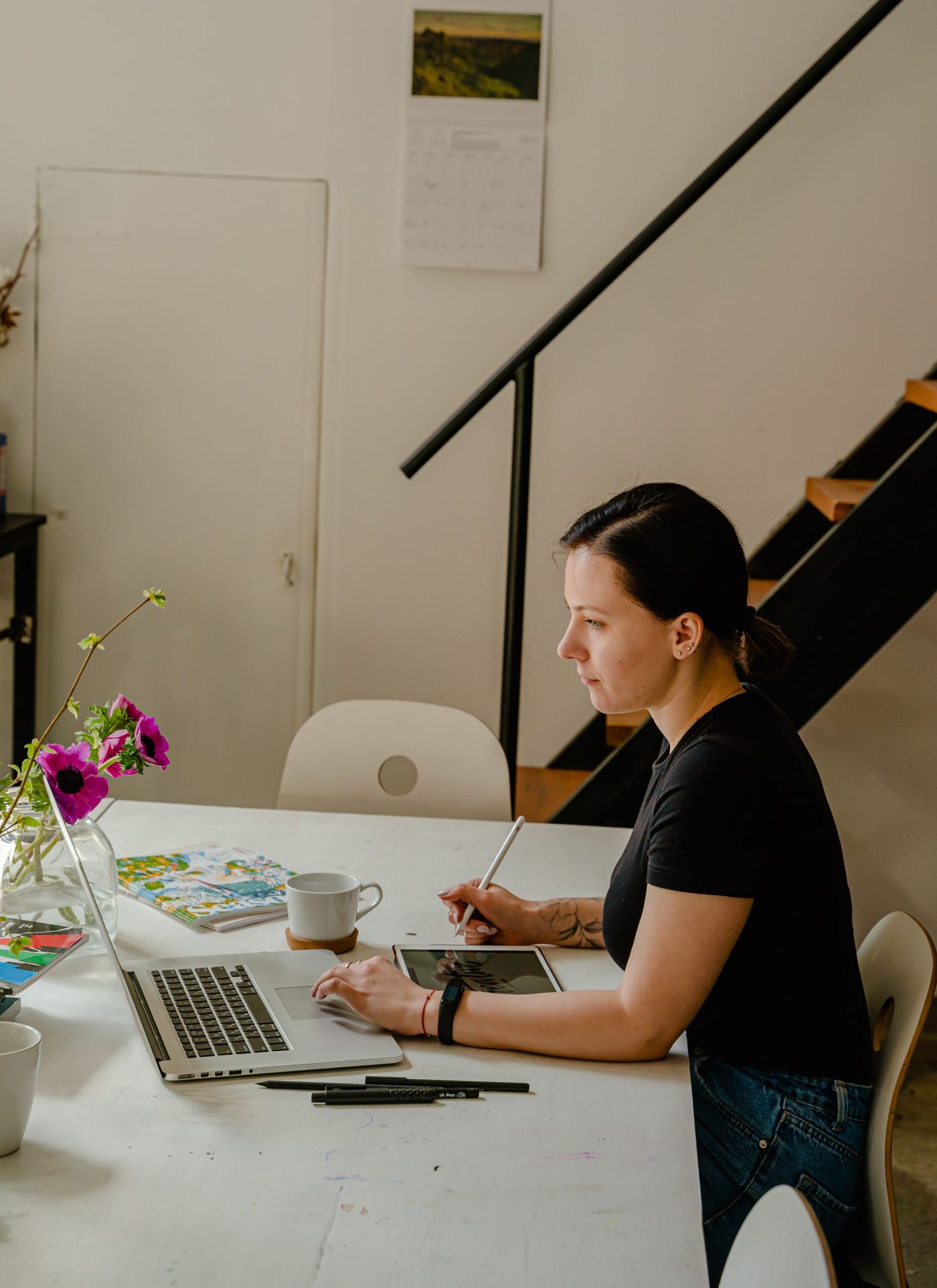 Designer at a table working on a laptop