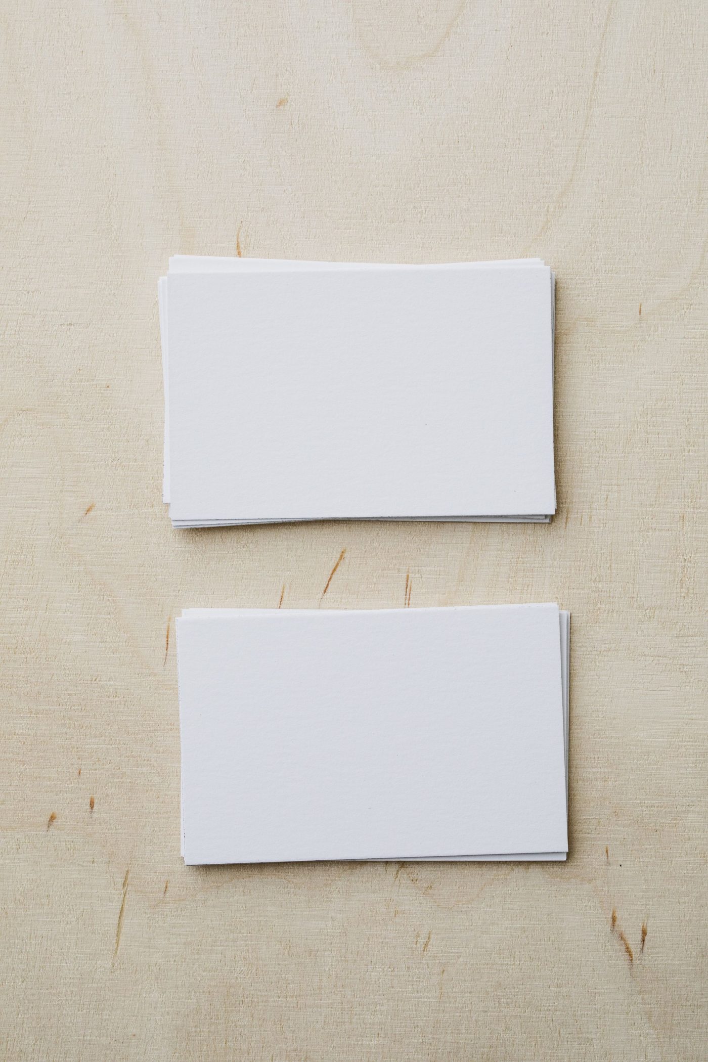 Stacks of blank white business cards on a table