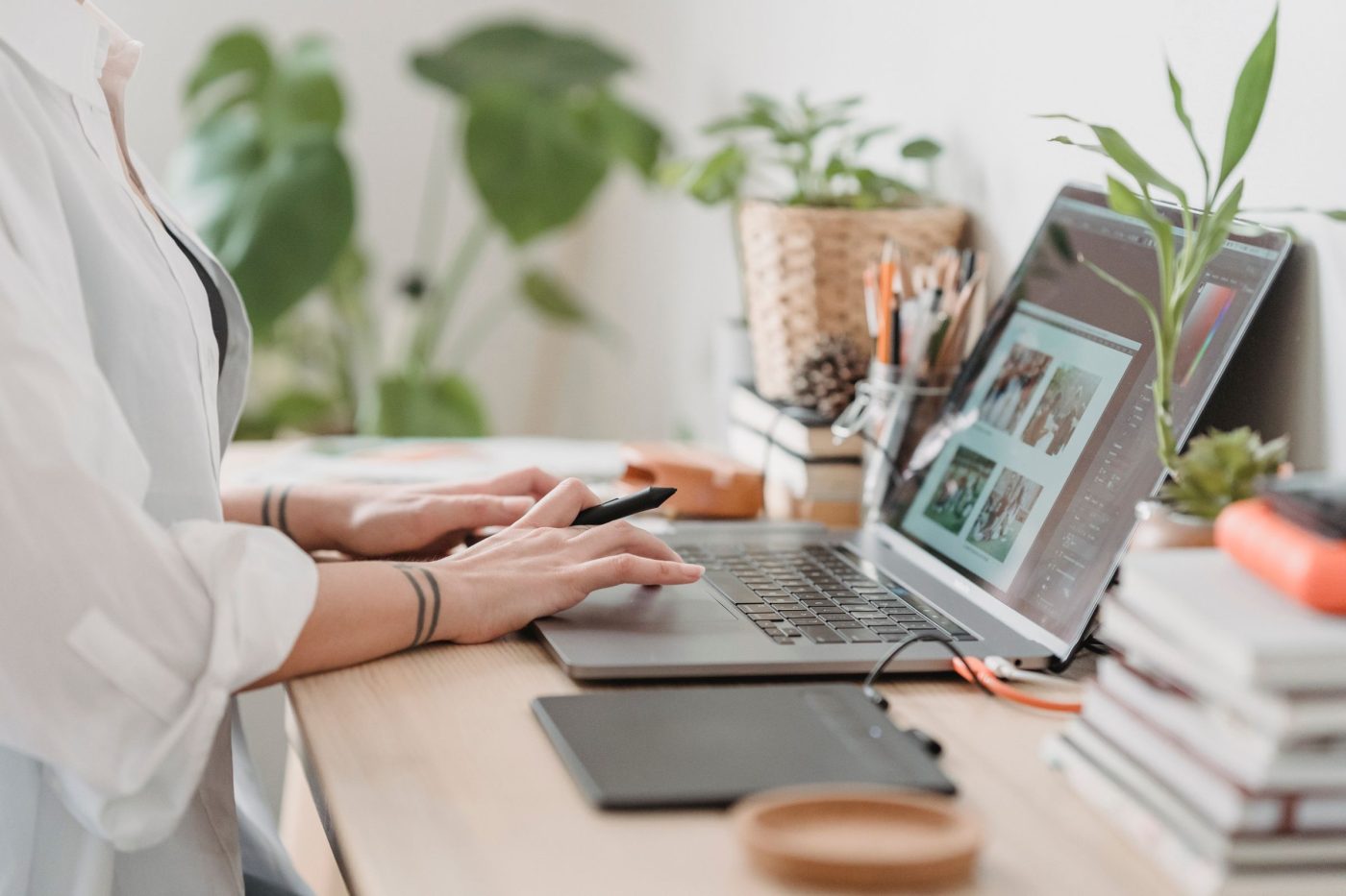 Designer retouching a photograph at a tidy workspace