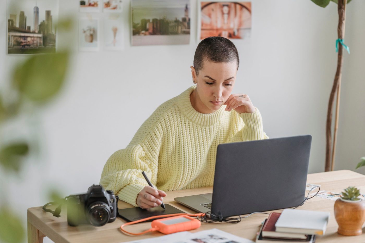Designer drawing on a graphics tablet beside a laptop