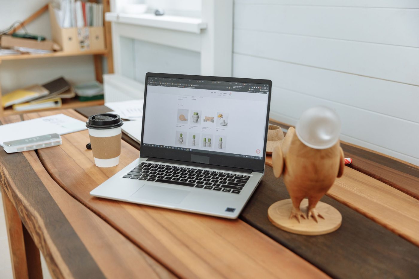 Laptop on a wooden table showing a design studio website