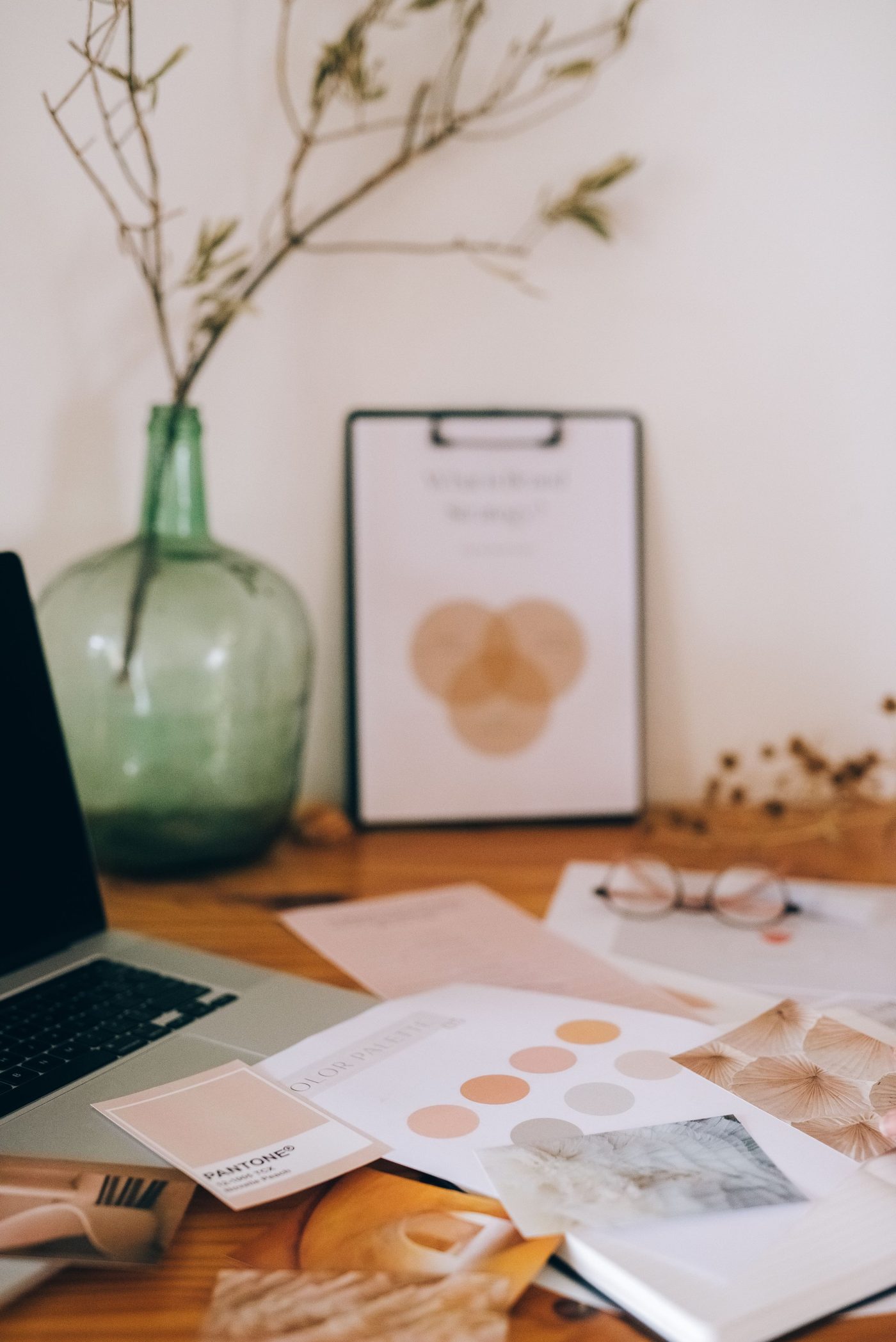 Brand guidelines and colour palette pages on a designer's desk